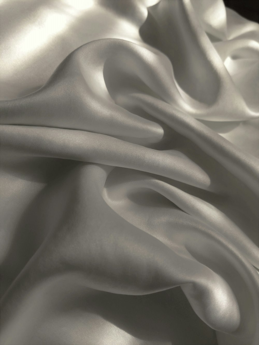 a black and white photo of a satin fabric