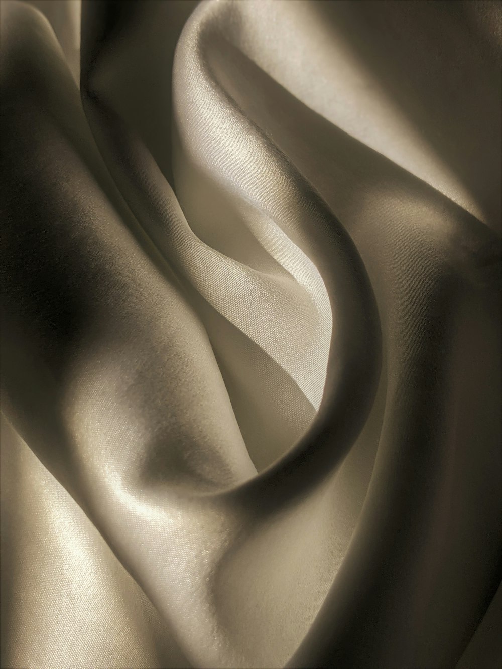 a black and white photo of a wavy fabric