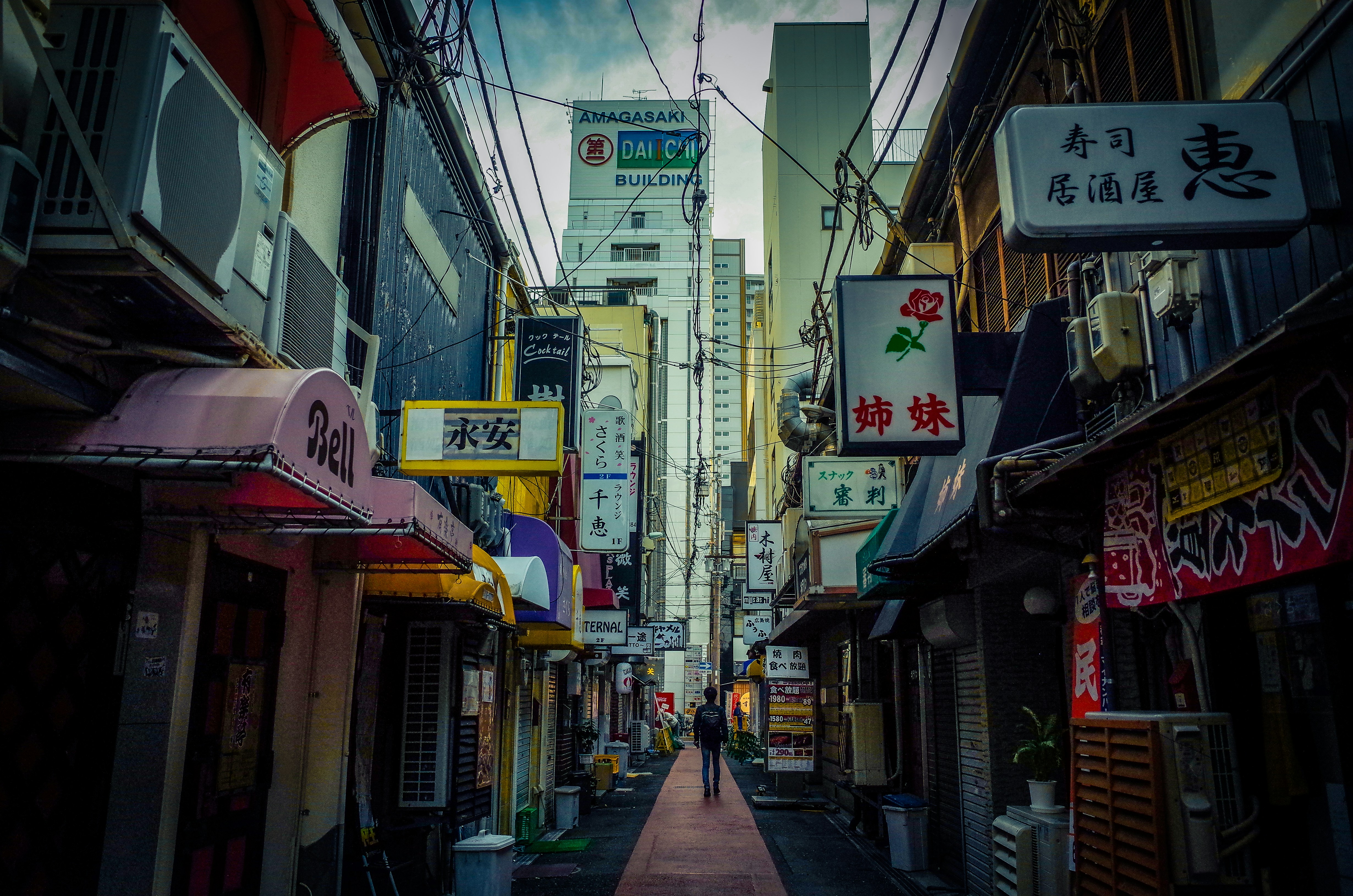 a narrow city street lined with tall buildings