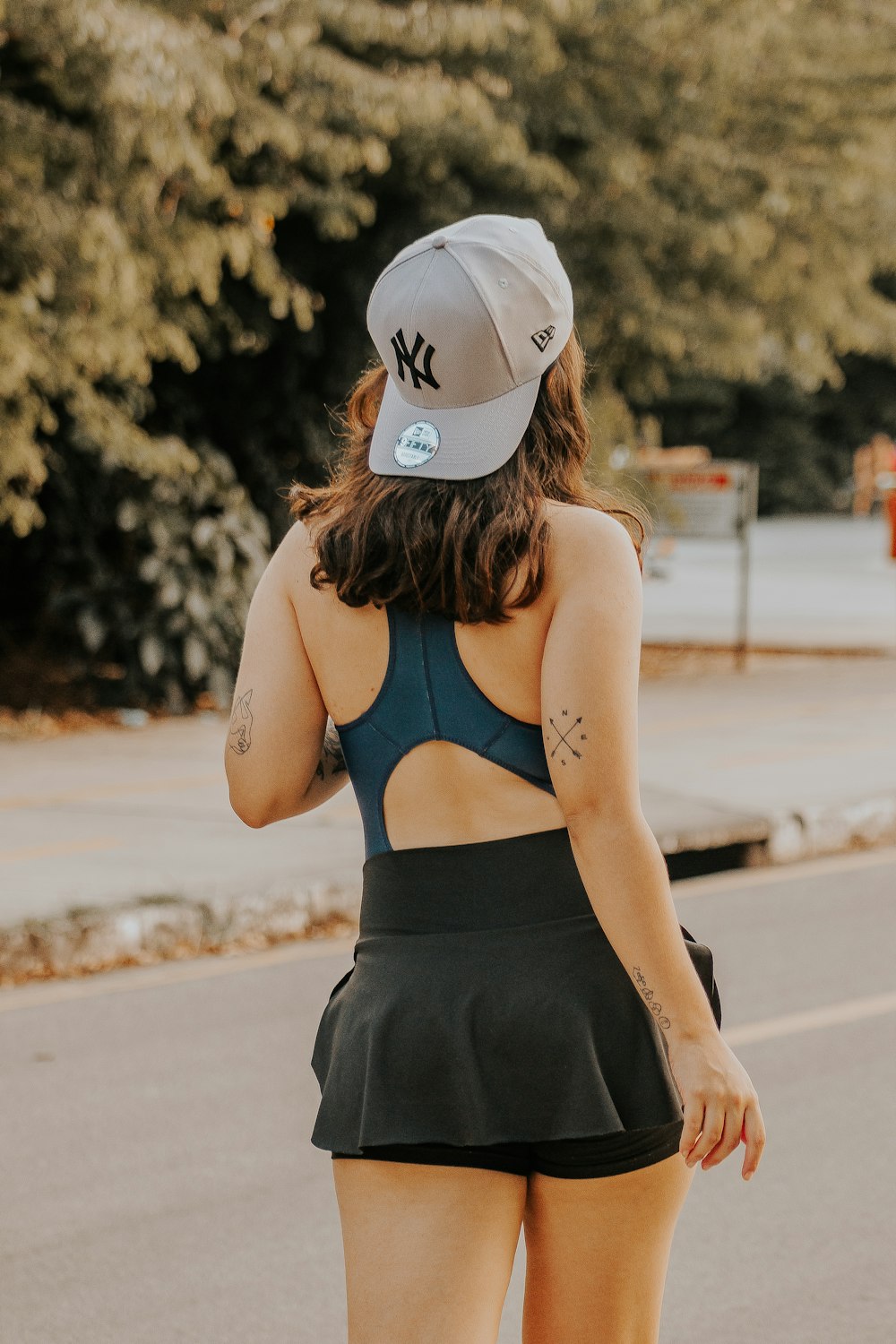 a woman riding a skateboard down a street