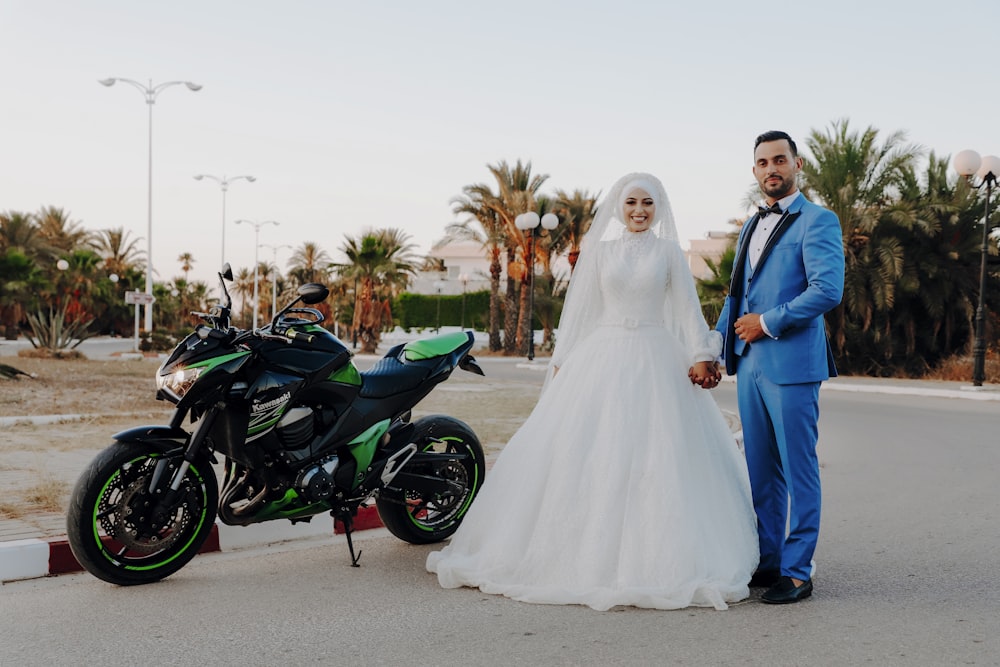 a bride and groom standing next to a motorcycle