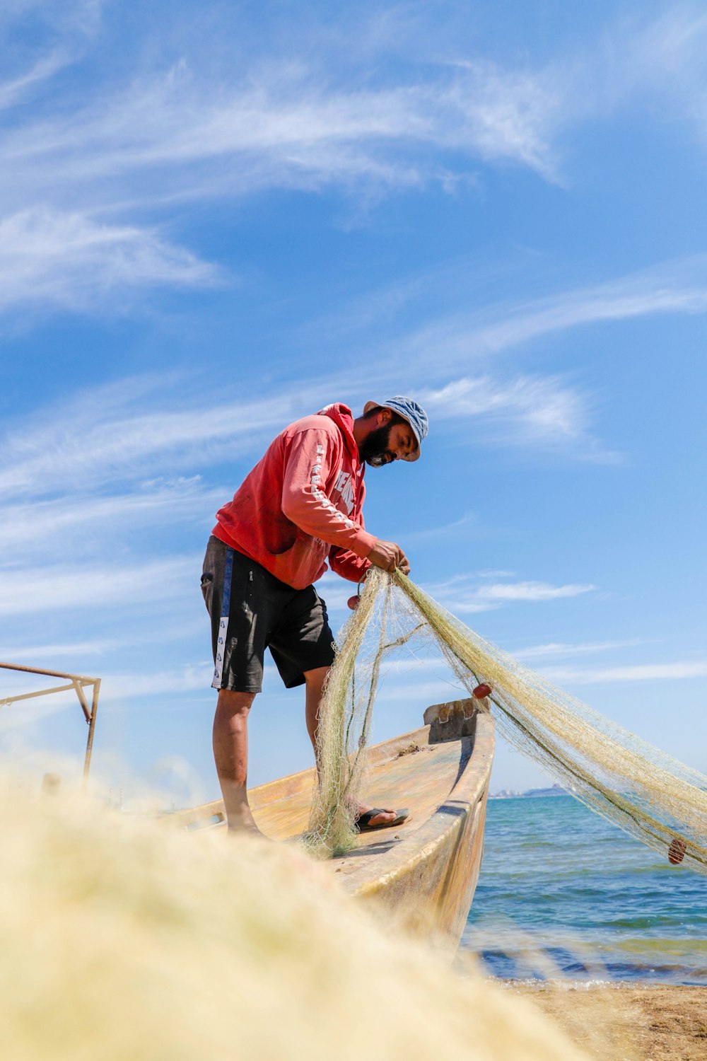 a man standing on top of a boat holding a net