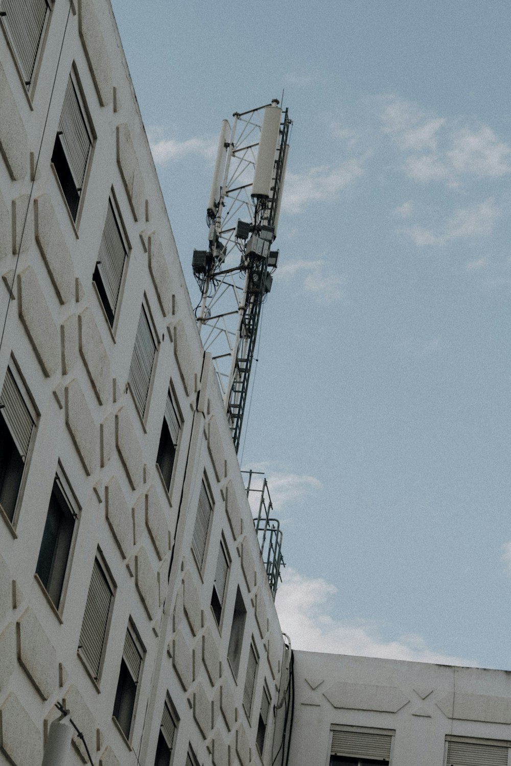 a tall white building sitting next to a tall white building