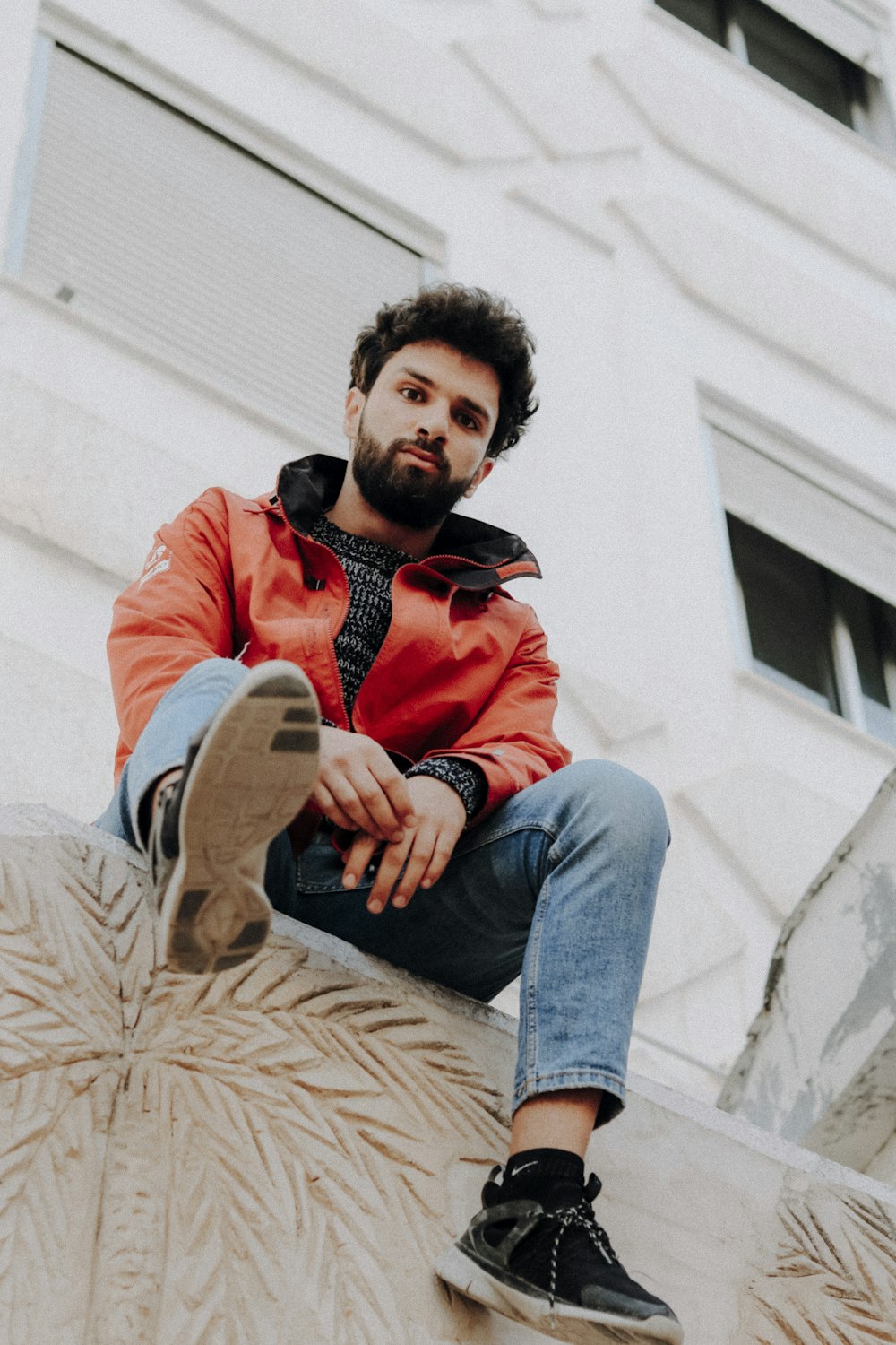 a man sitting on top of a cement structure