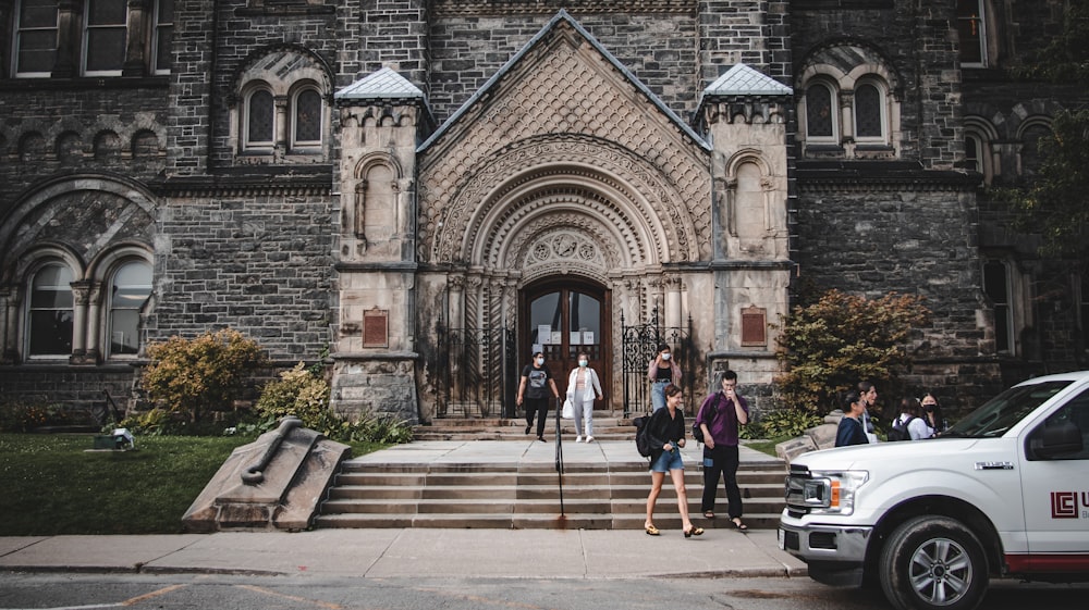 a group of people standing in front of a church