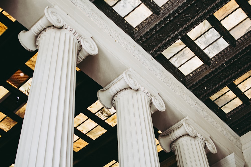 a couple of white pillars in a building