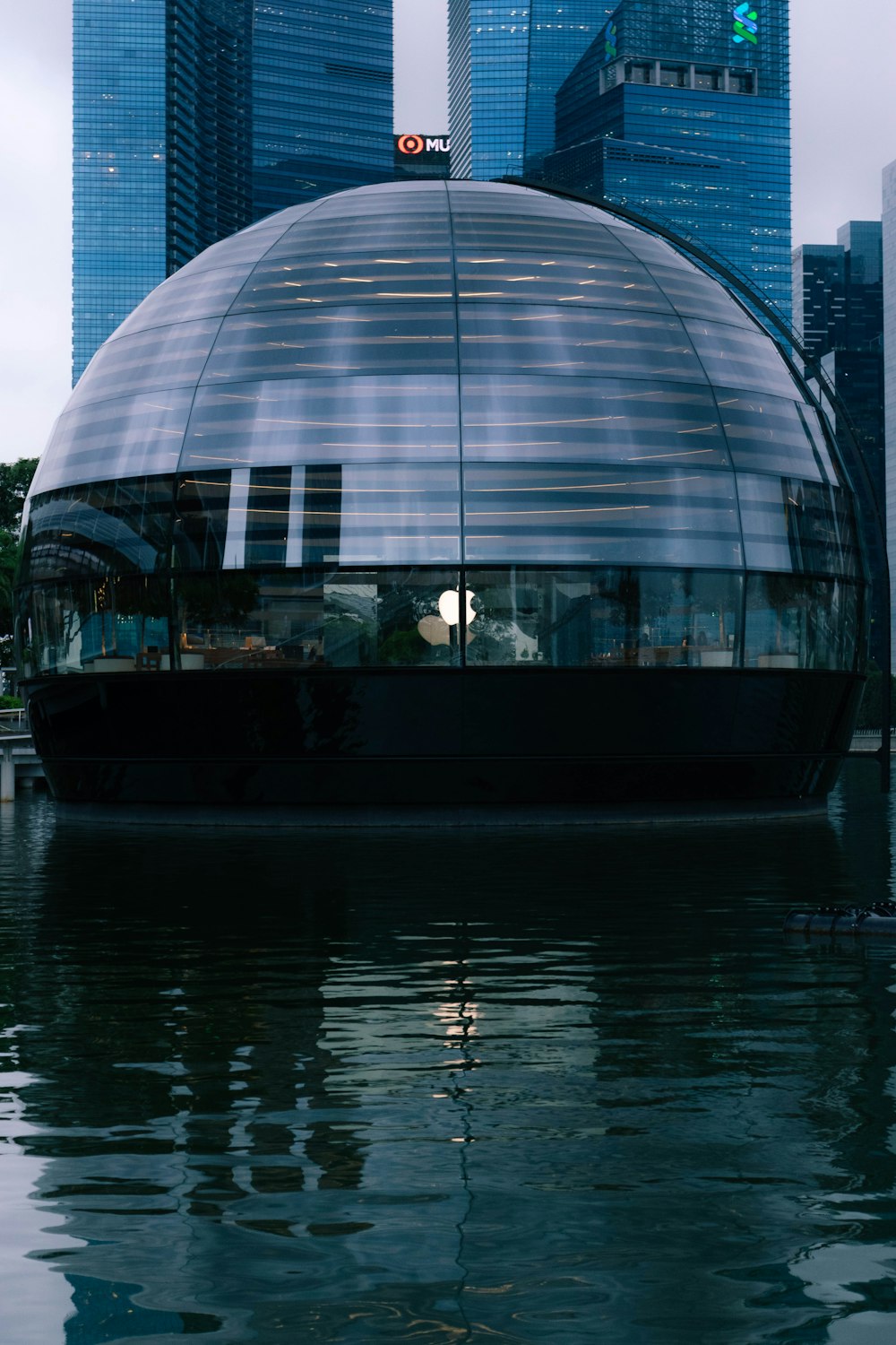 a large glass dome sitting in the middle of a body of water