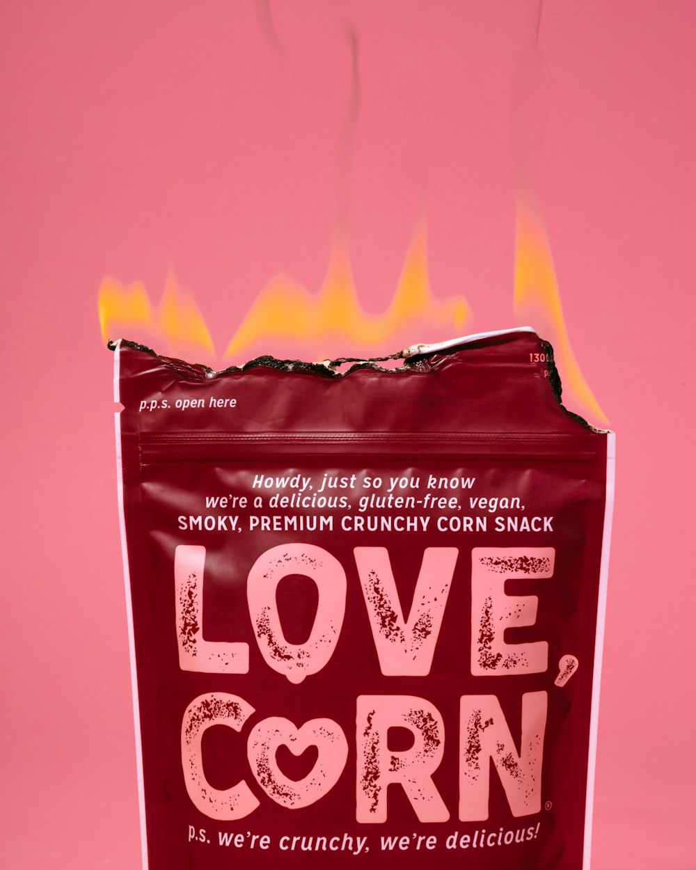 a bag of love corn on a pink background