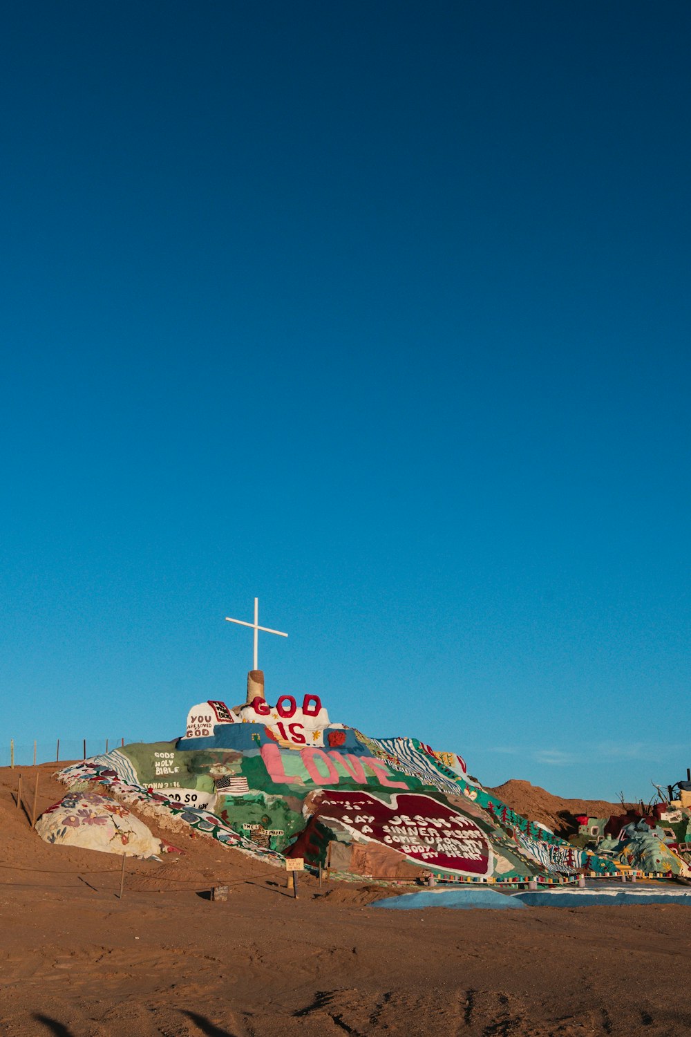 a hill with a cross on top of it