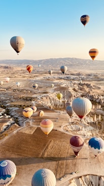 a bunch of hot air balloons flying in the sky