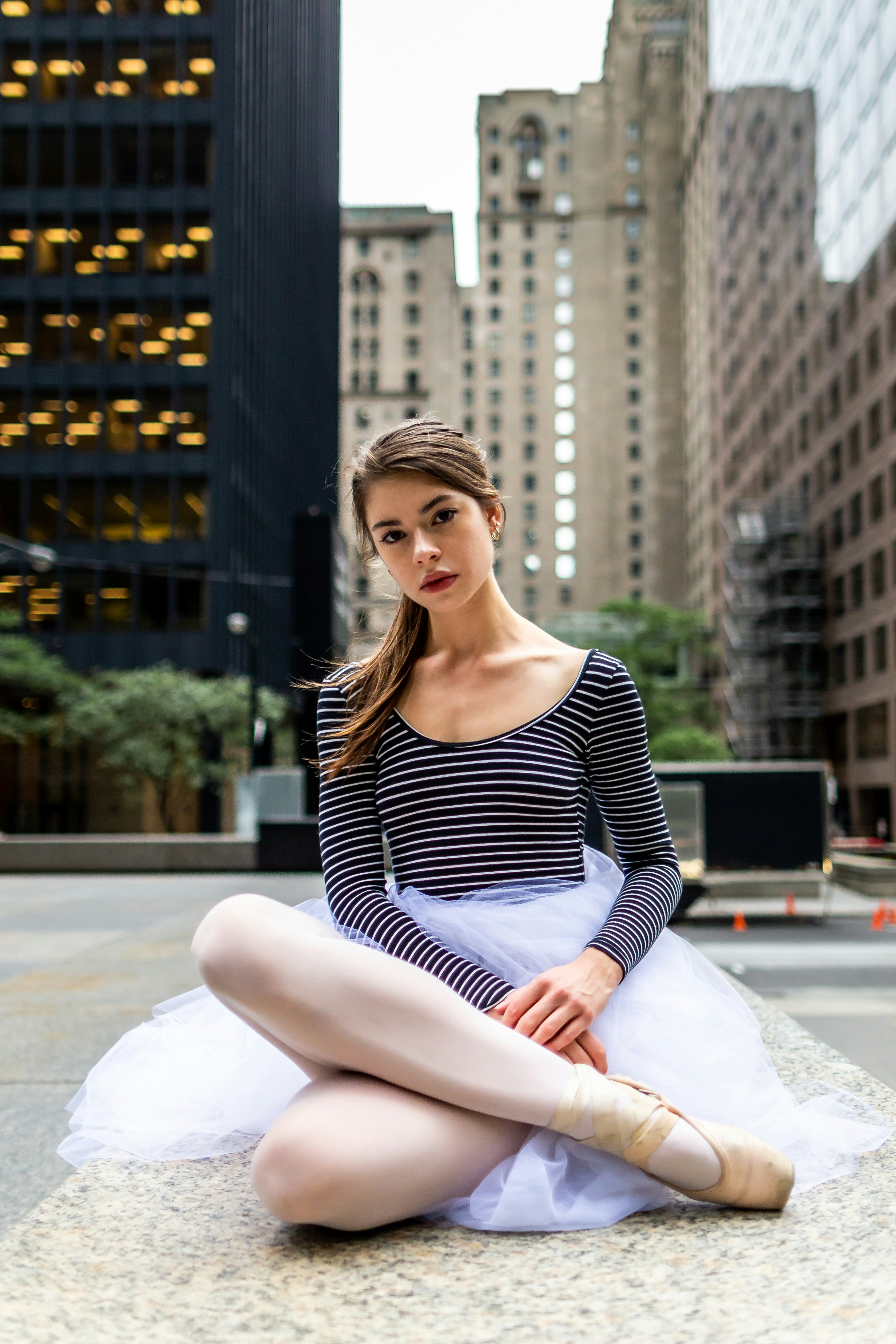 a woman sitting on the ground in a tutu