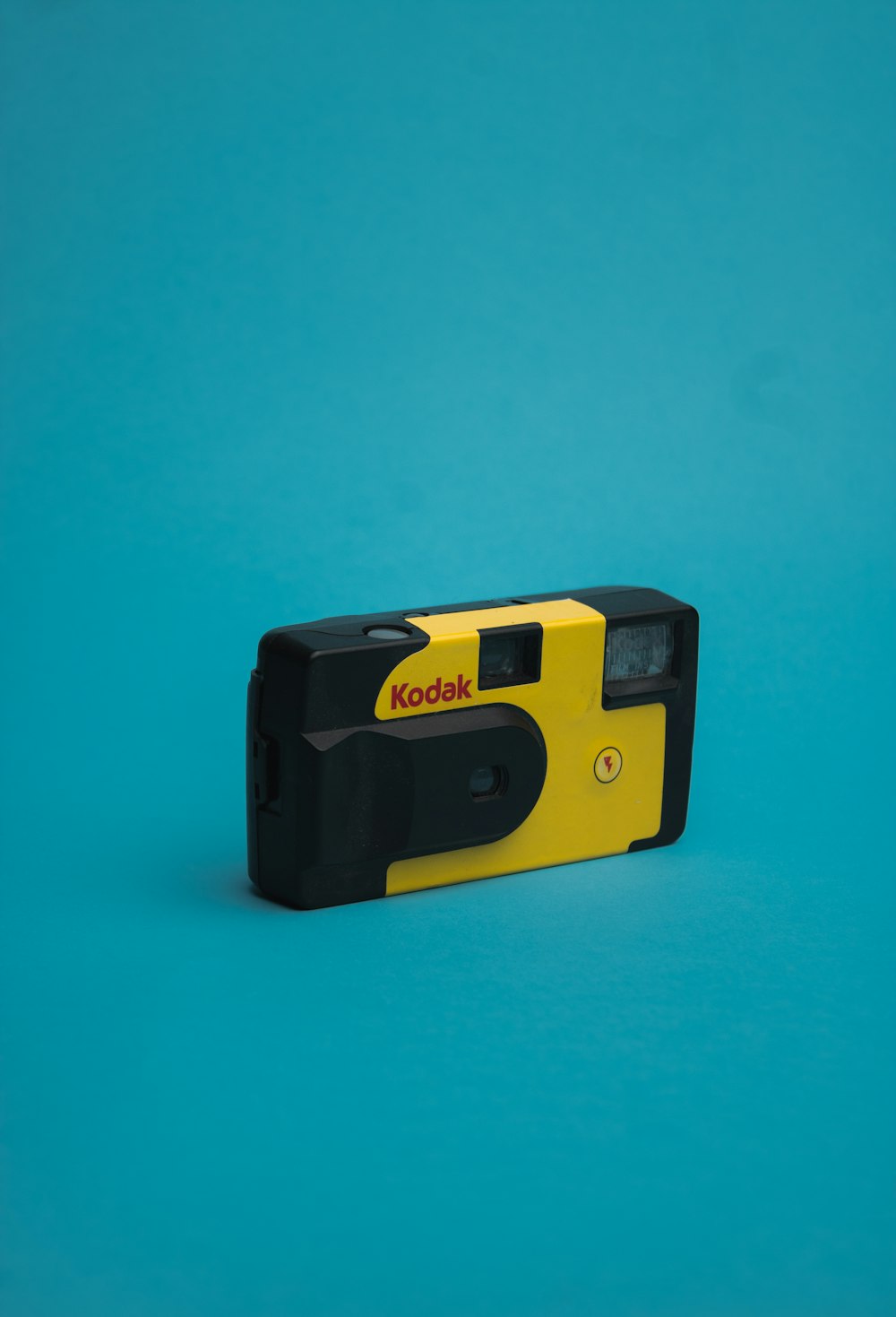 a yellow and black camera on a blue background