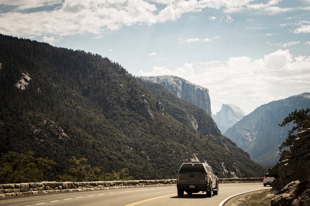 a van driving down a road in the mountains