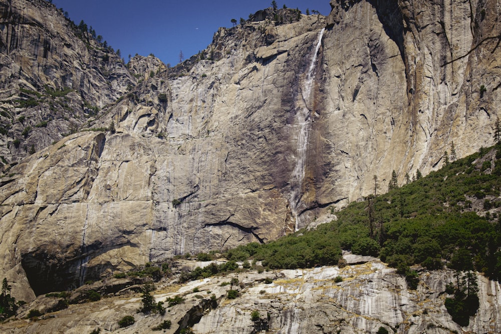 a large waterfall cascading into the side of a mountain