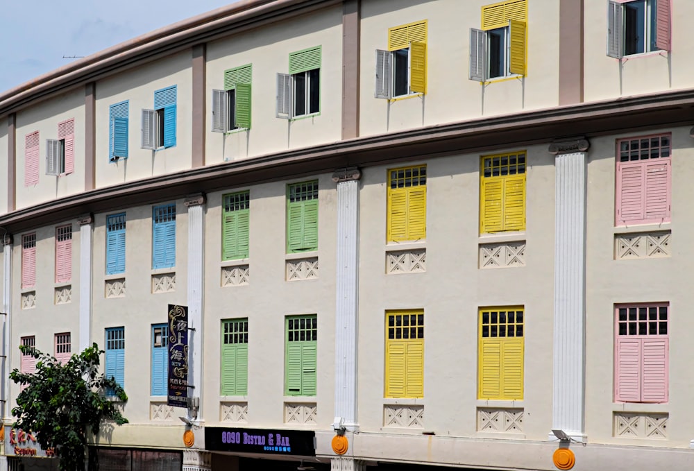 a multicolored building with a tree in front of it