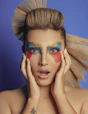 a woman with a colorful make - up on her face