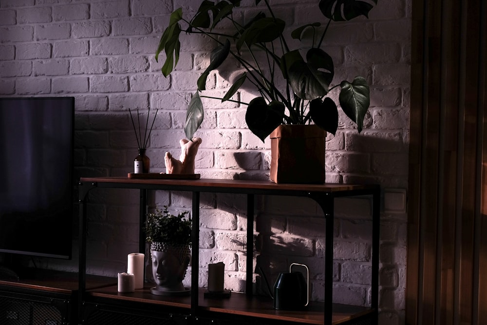 a living room with a brick wall and a television