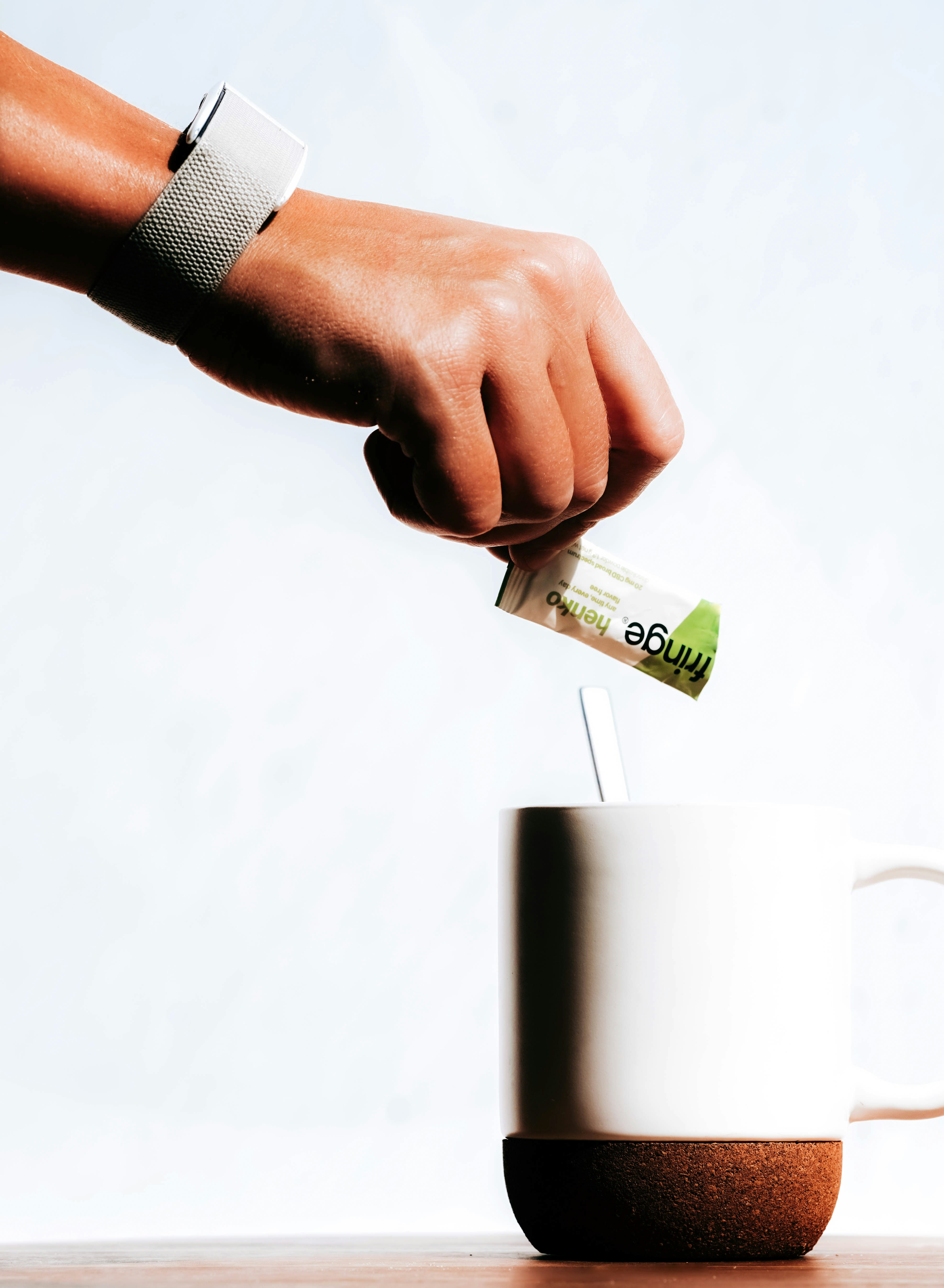 a person is putting money into a mug