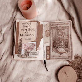 A peaceful scene of a mother writing in a journal, surrounded by gentle pink hues.
