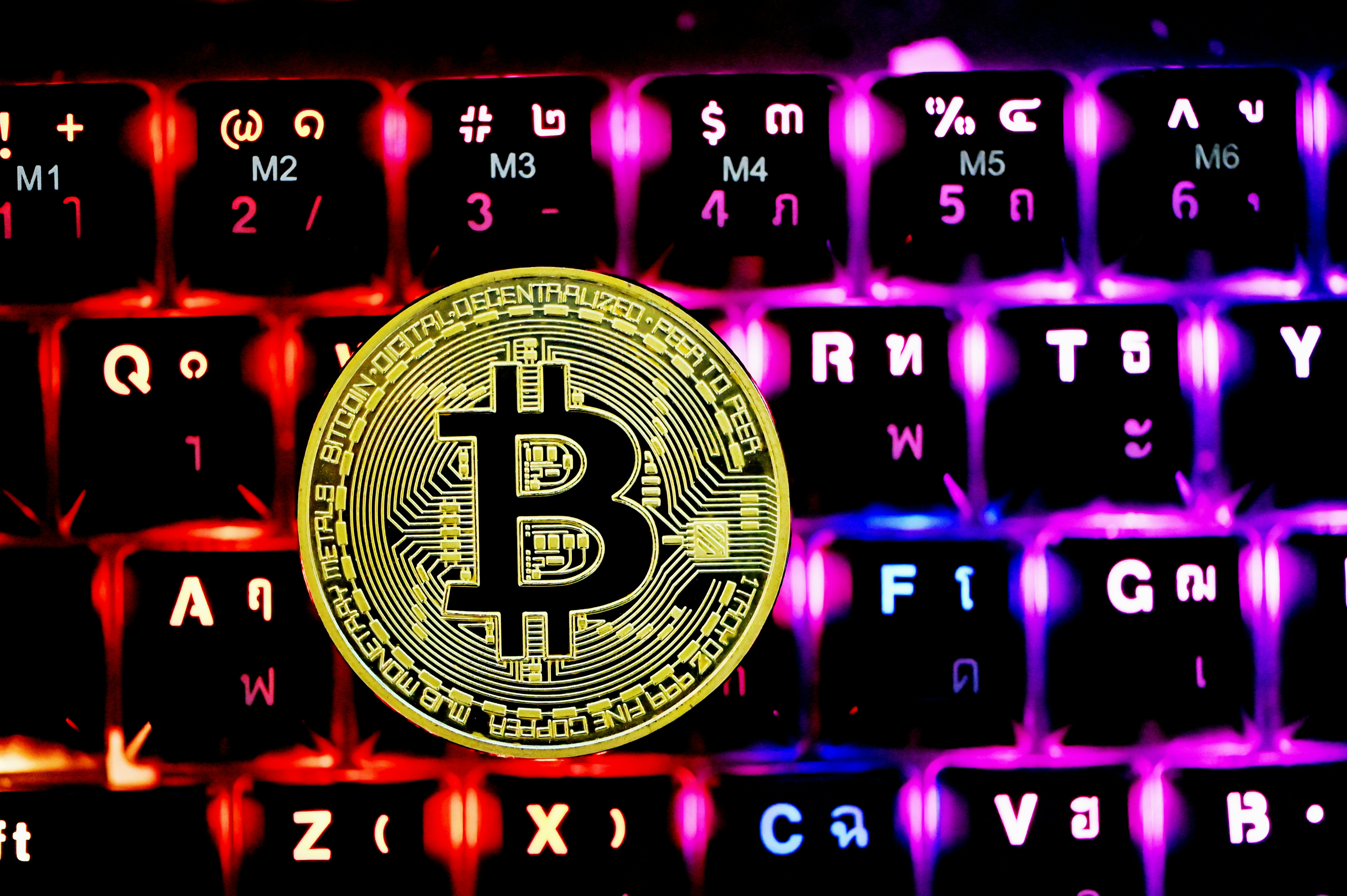 A Bitcoin on top of a keyboard