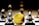A gold Ethereum token is prominently placed on a black and white chessboard surrounded by several metallic chess pieces. The focus is on the Ethereum symbol on the coin, while the chess pieces appear slightly out of focus in the background. The lighting emphasizes the reflective surfaces of both the coin and the chess pieces.