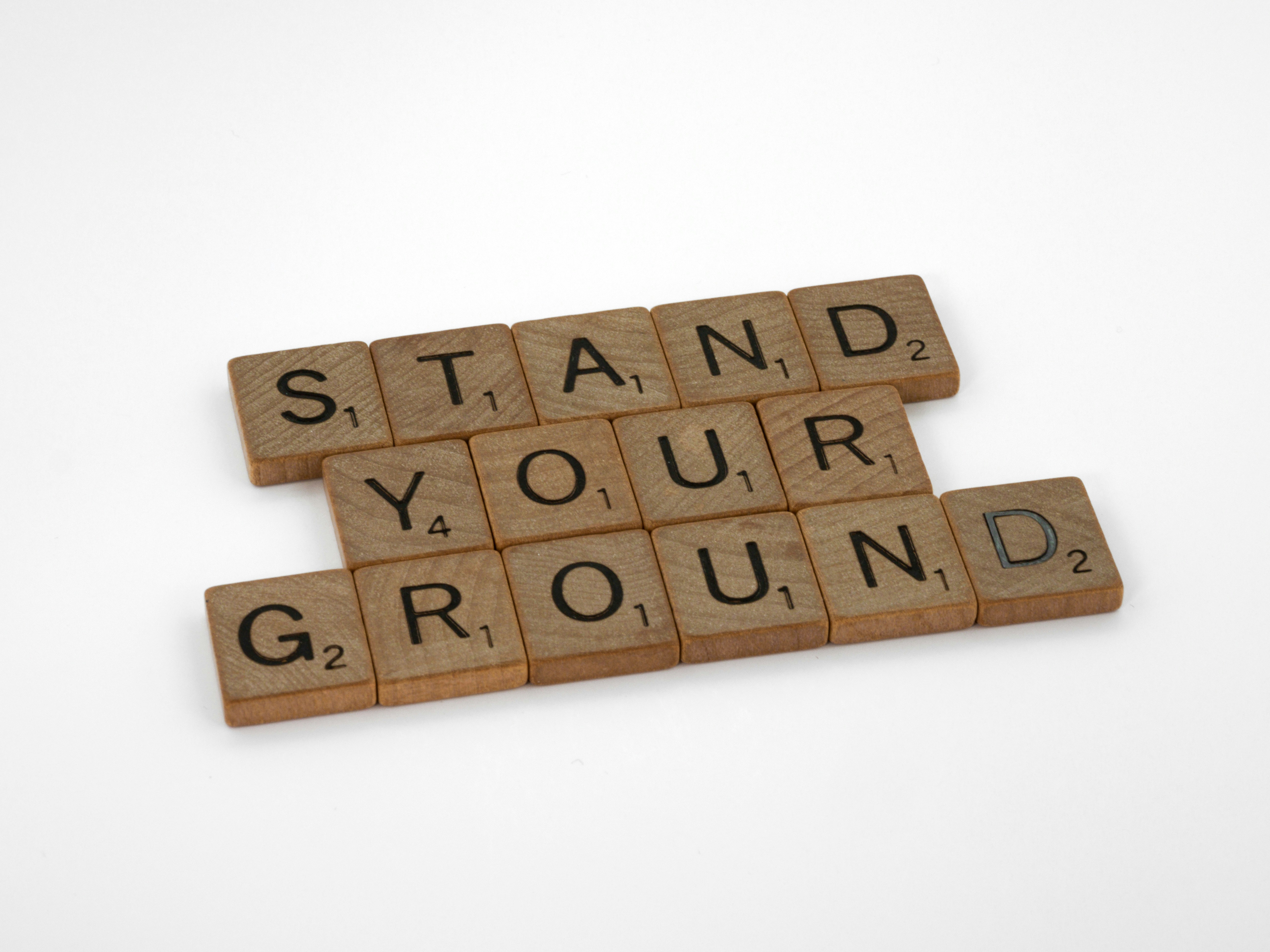 scrabble tiles spelling the words stand your ground