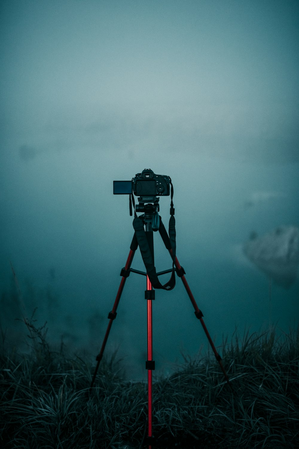 a camera on a tripod on a foggy day