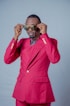 a man in a pink suit and sunglasses