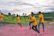 A group of friends wearing bright, custom-printed sports t-shirts outdoors.