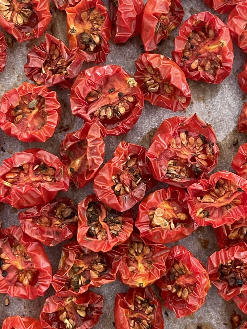 a bunch of red peppers sitting on top of a counter