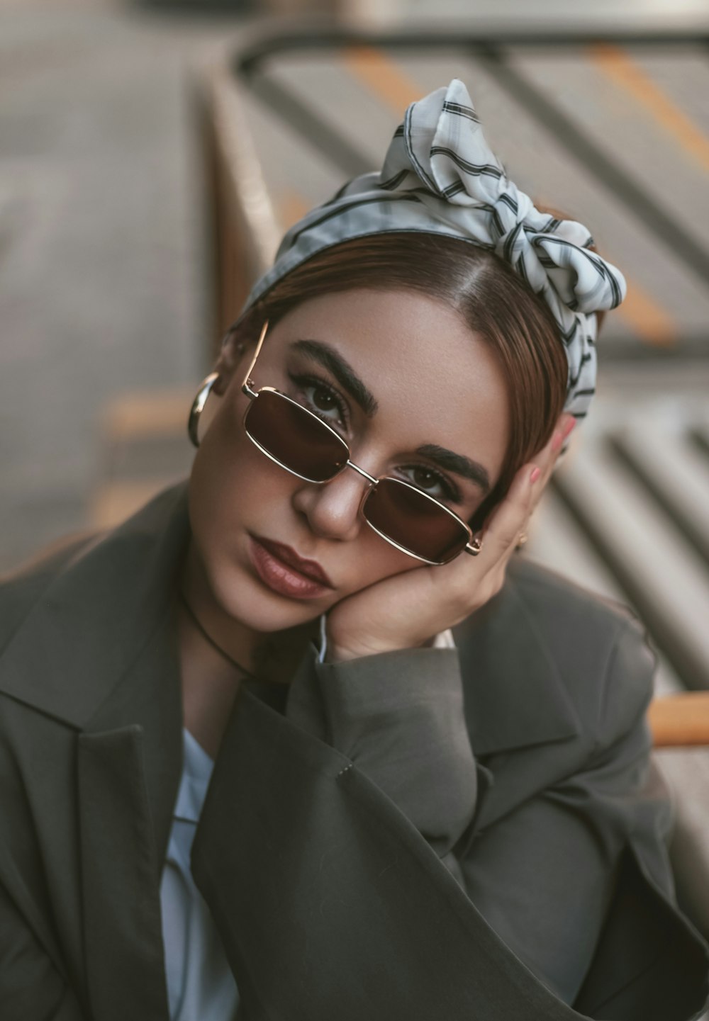 a woman wearing sunglasses and a head scarf