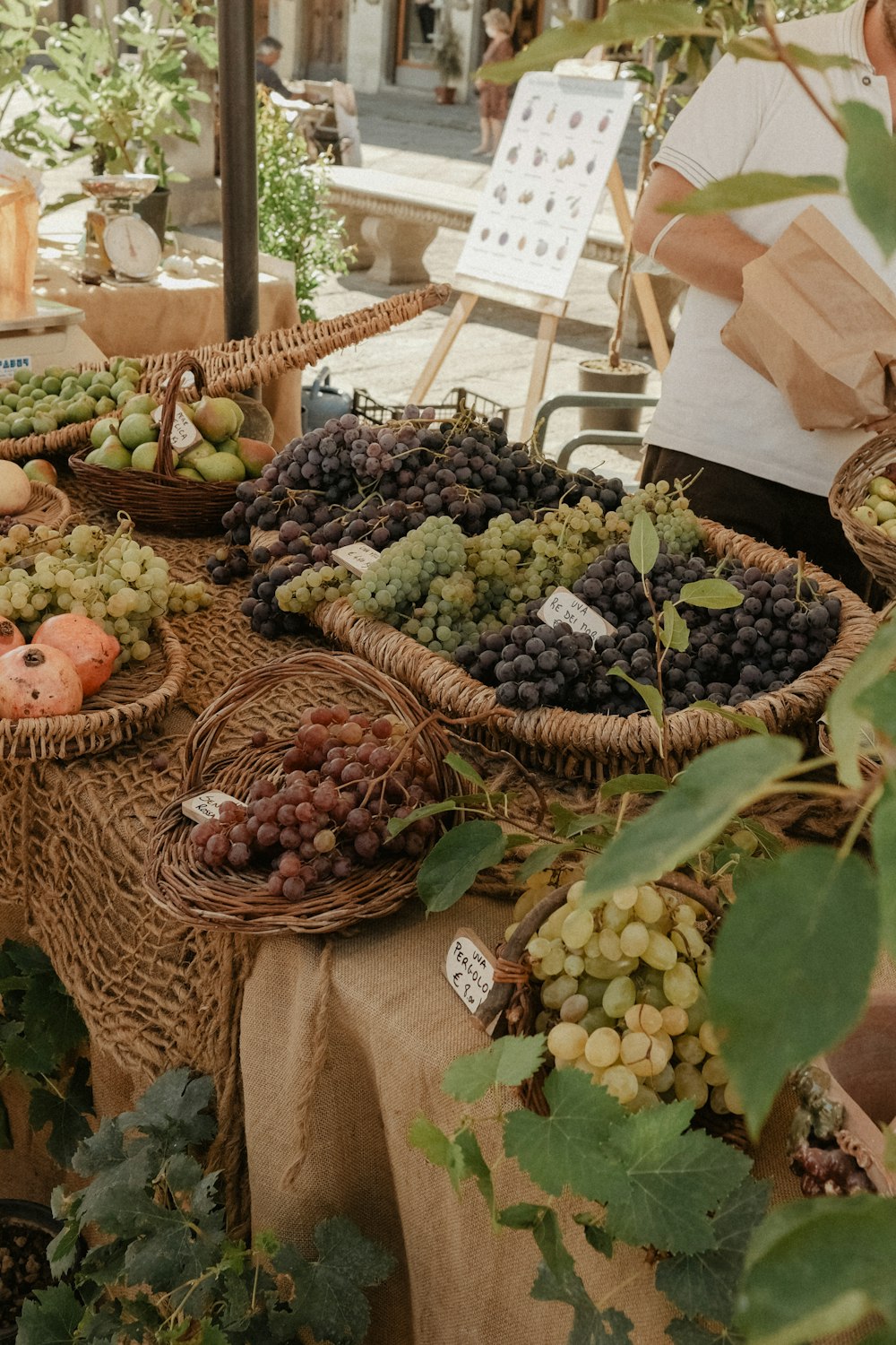 a table topped with baskets filled with lots of fruit