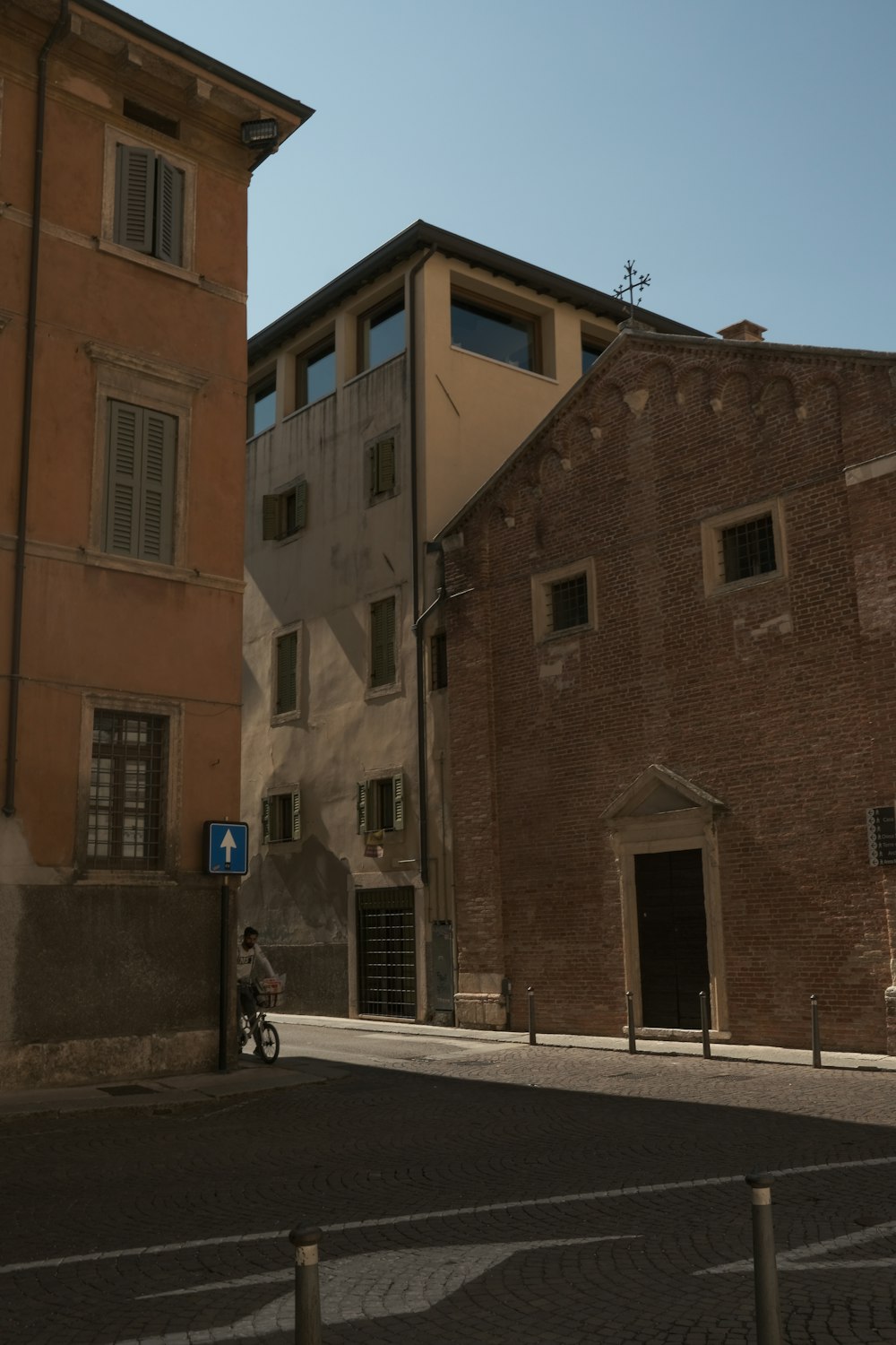 a person riding a bike down a street next to tall buildings