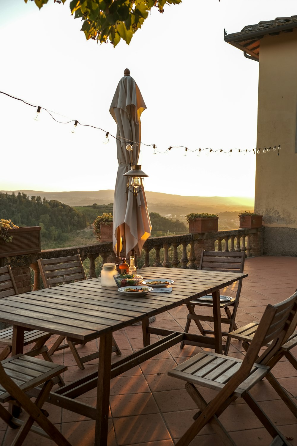 a patio with a table and chairs and an umbrella