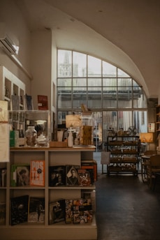 a room filled with lots of books and furniture