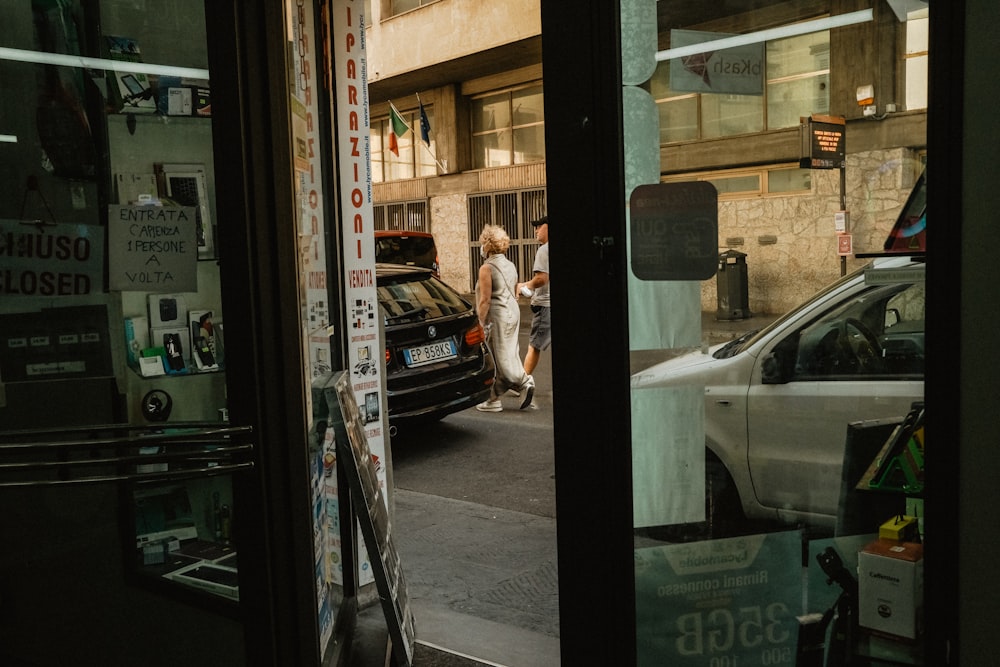 a couple of people that are walking down a street