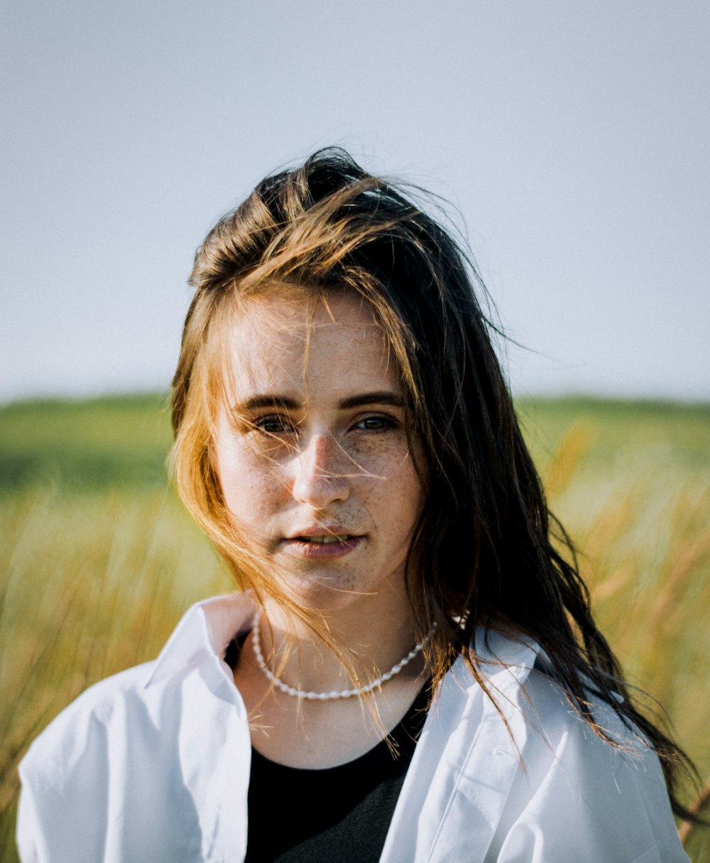 a woman standing in a field of tall grass