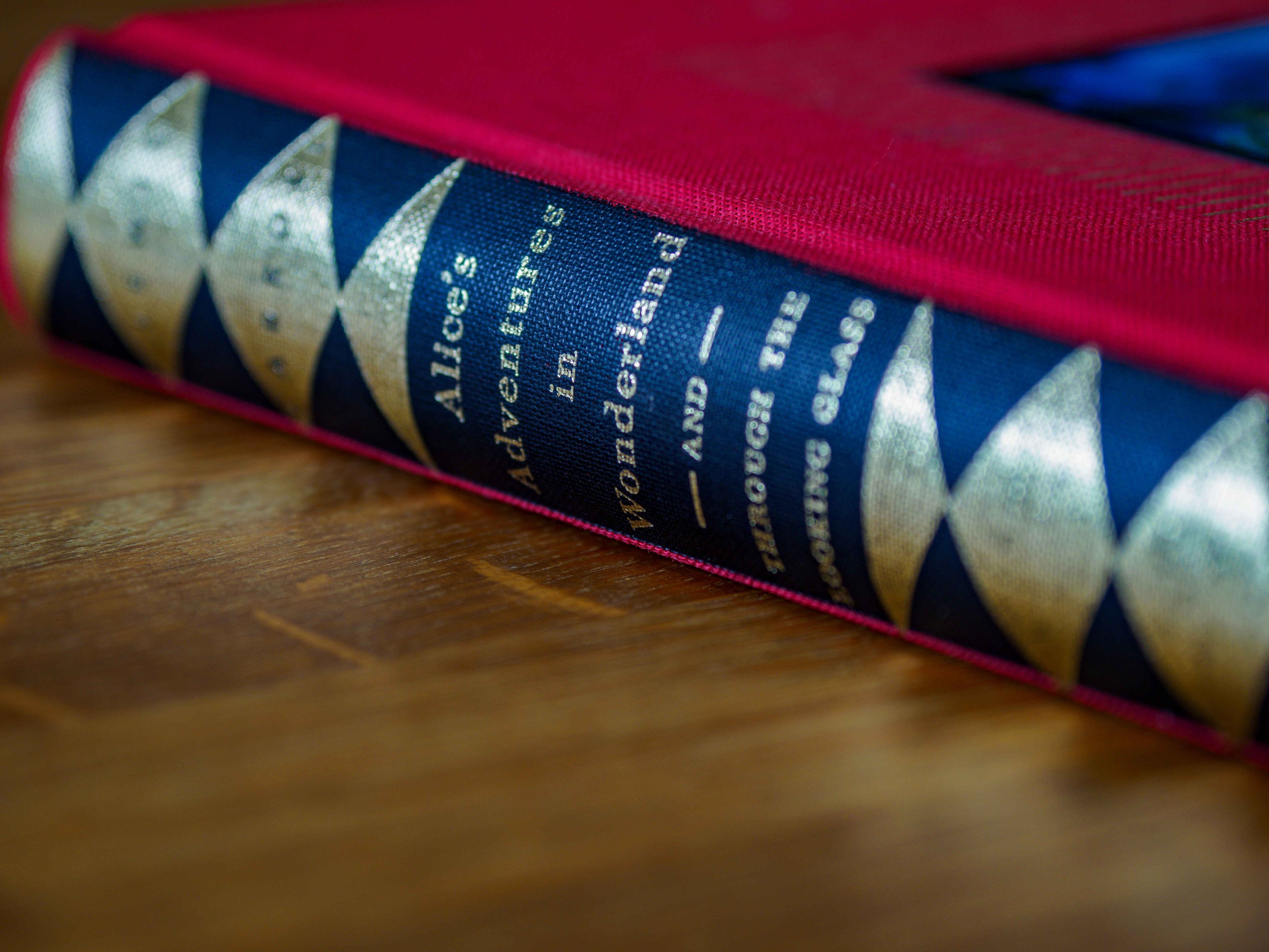 a red and blue book sitting on top of a wooden table