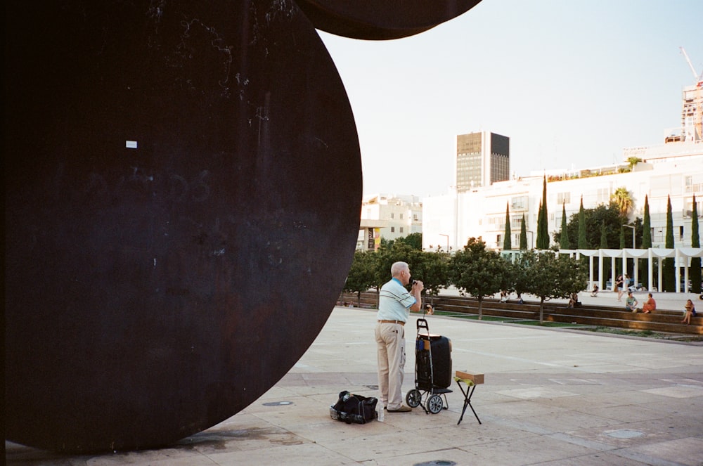 a man standing next to a large metal object