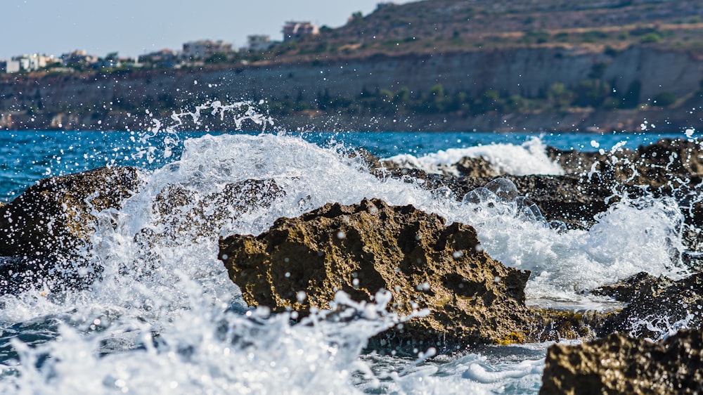 a large body of water next to a rocky shore