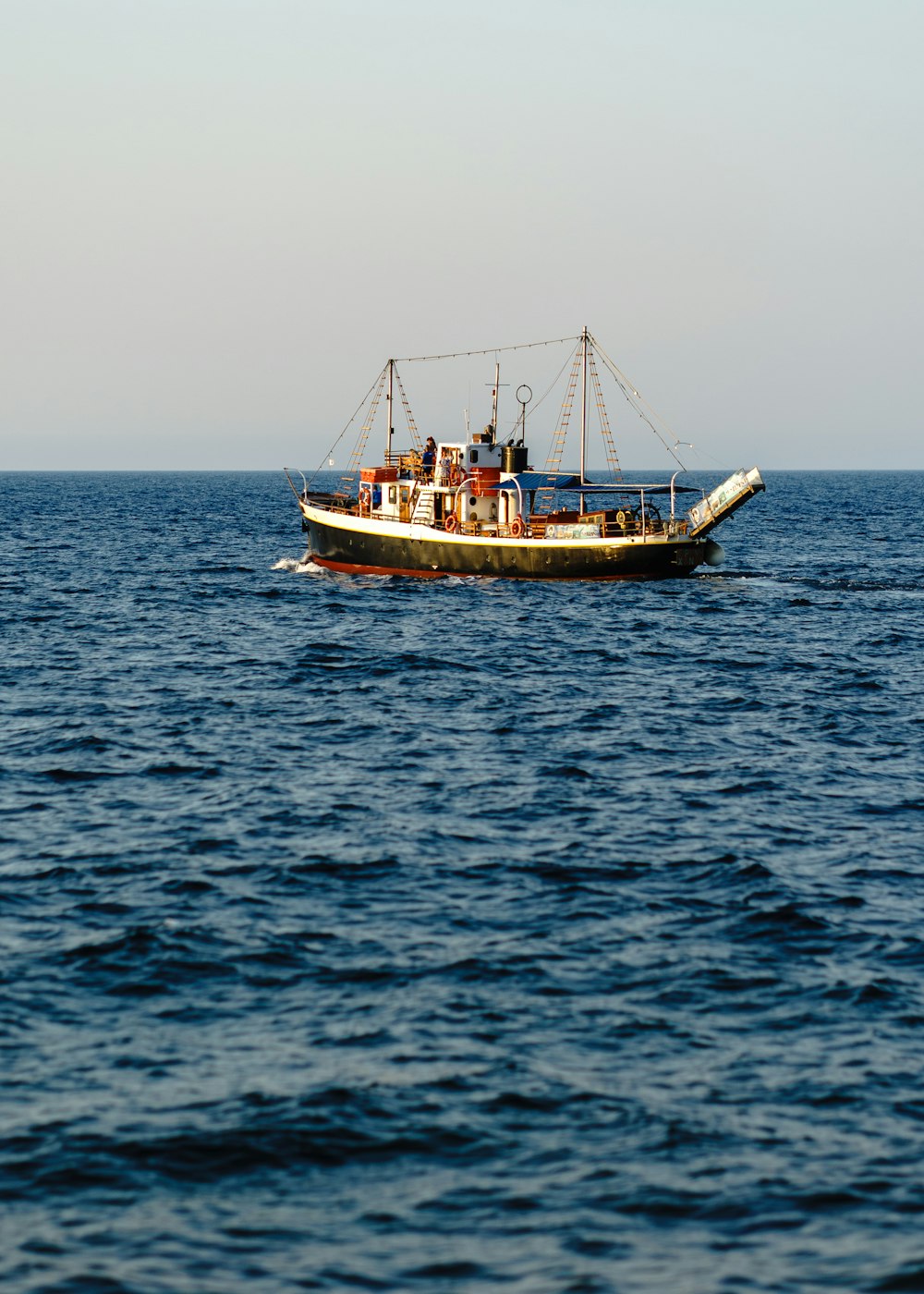 a boat floating on top of a large body of water