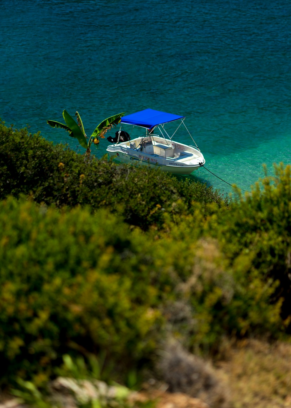 a small boat floating on top of a body of water