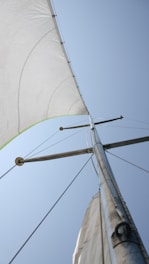 a white sail with a green stripe on it