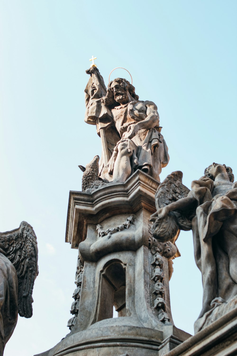 a statue on top of a building with a sky background