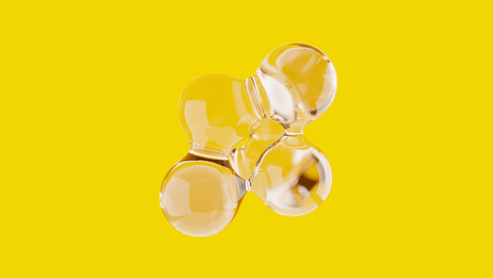 a group of three glass balls on a yellow background