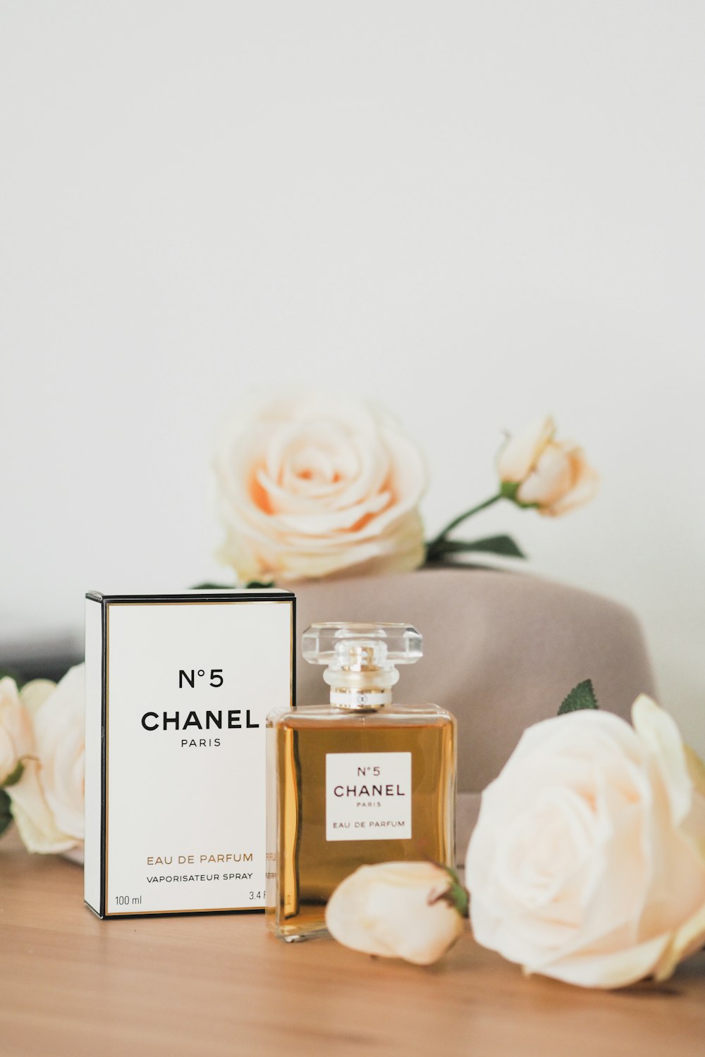 a bottle of chanel no 5 next to some flowers