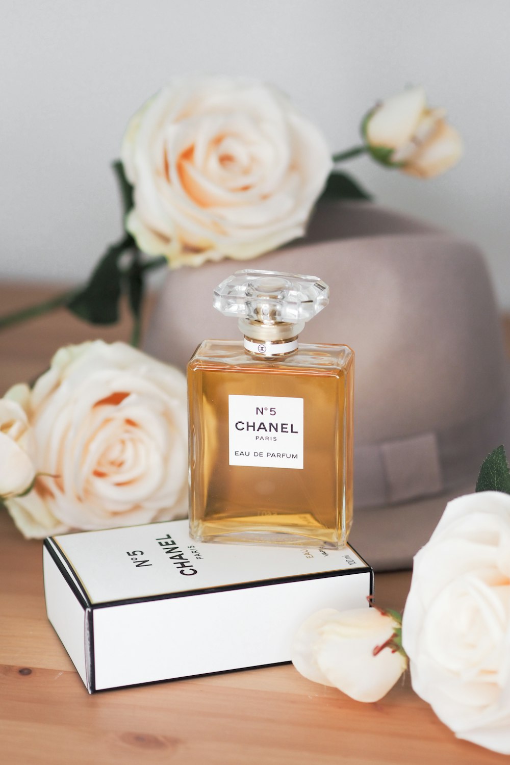A bottle of chanel perfume sitting on top of a box photo – Free Grey Image  on Unsplash