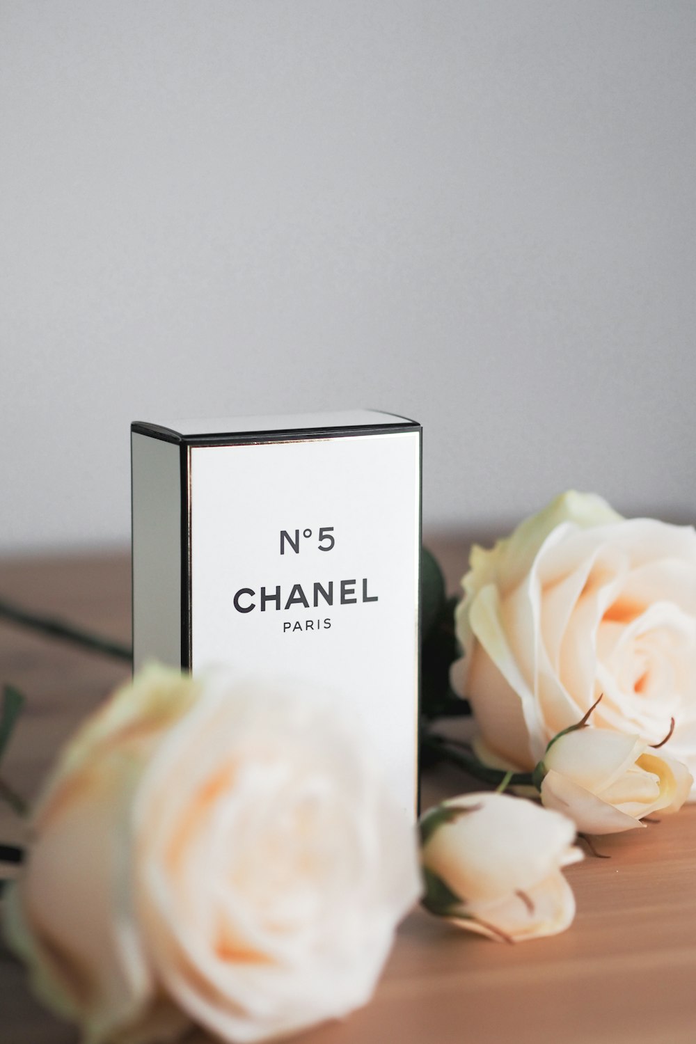 A box of chanel perfume next to flowers photo – Free Plant Image on Unsplash