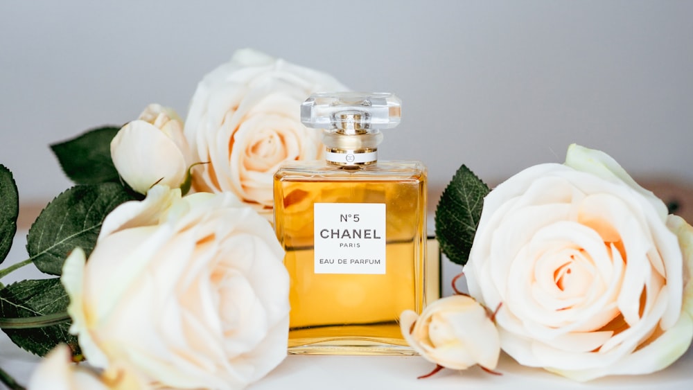 a bottle of chanel no 5 surrounded by flowers