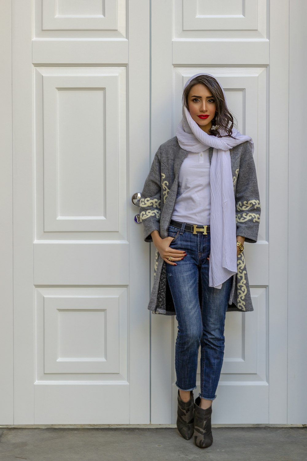 a woman standing in front of a white door